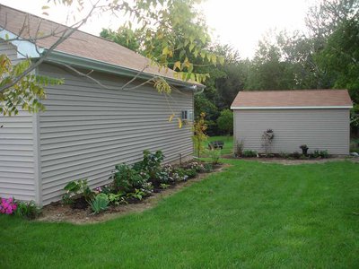 After Planting, the maple tree at the other end didn't make it past the first season.   The rest is hostas and 2 Annabelle Hydrangeas.  Oh, and a dwarf iris on the end.