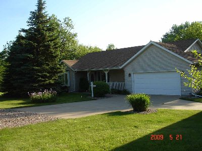 This is the front of the house from the street.   An additional building, my DH's shop, is to the right, out of the picture.  The grass in the center of the picture makes a beautiful big mound by mid-summer.